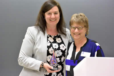 Carrie Grady receives award from Wendy Heller