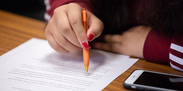 student writing on paper