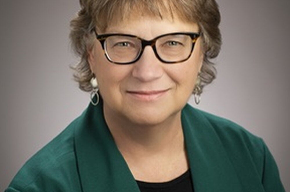 Wendy Heller profile picture wearing dark green sweater and glasses