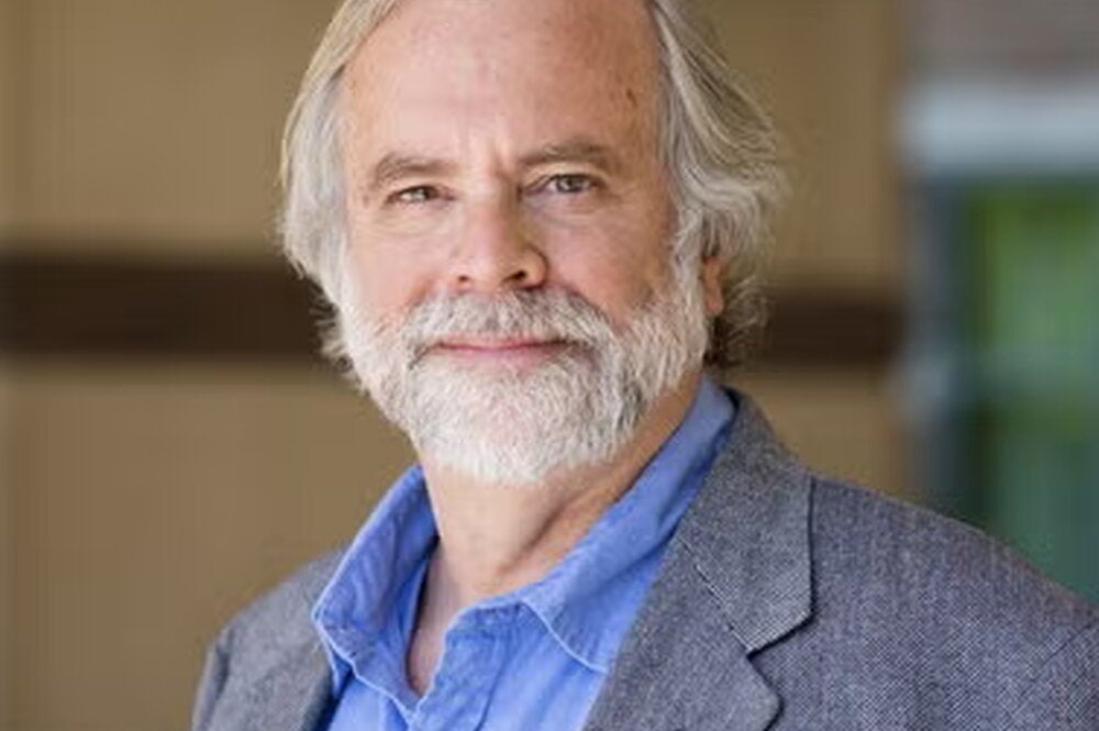 Art Kramer wearing a light blue button up shirt and blazer.