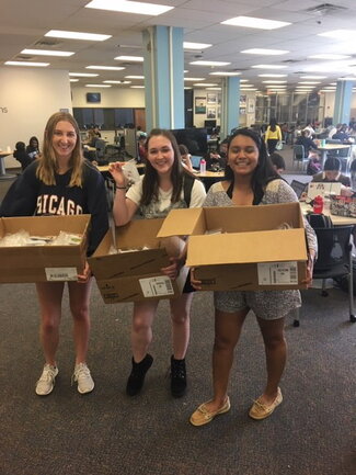 Distributing 2019 spring stress packets: L-R: Grace, Sarah, Insia