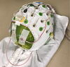 Small watermelon wearing a white EEG electrode cap with wires attached