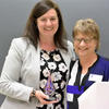 Carrie Grady receives award from Wendy Heller