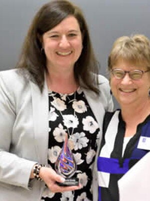 Carrie Grady receives award from Wendy Heller